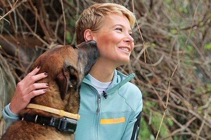 Julia Vysotskaya with a Belgian Shepherd Dog