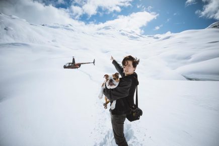 Cole with a dog in the snowy mountains